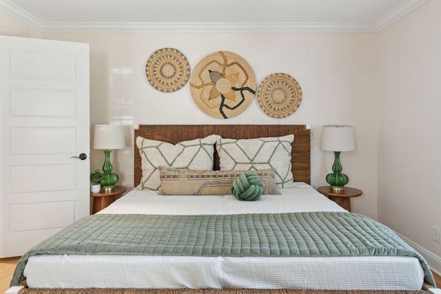 bedroom featuring ornamental molding and wood finished floors