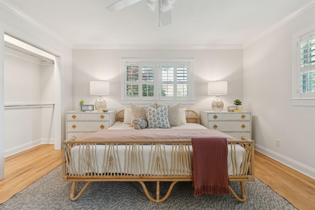 bedroom featuring crown molding, baseboards, and wood finished floors