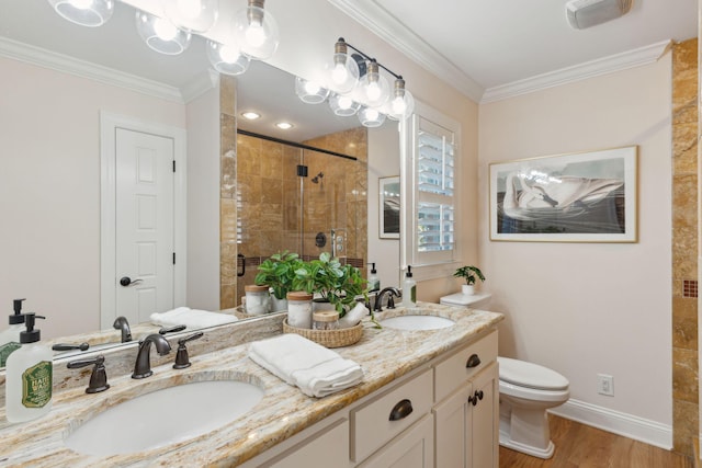 full bathroom with a sink, ornamental molding, a shower stall, and wood finished floors