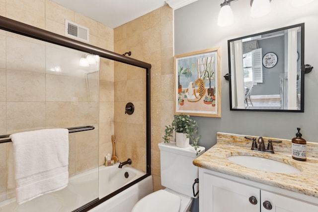 full bathroom with vanity, combined bath / shower with glass door, toilet, and visible vents