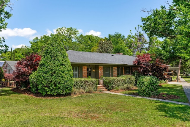 ranch-style house with a chimney and a front yard