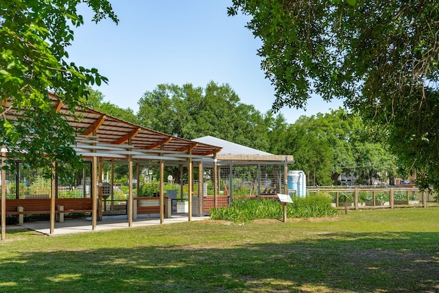 view of home's community with a yard and a garden