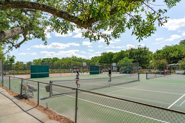 view of tennis court with fence