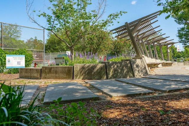exterior space featuring fence and a pergola