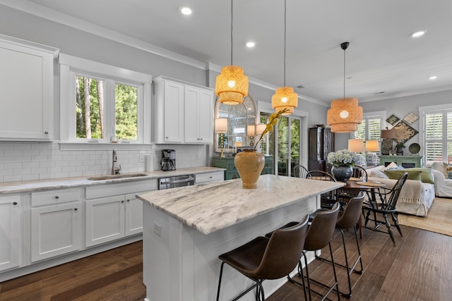 129 Martins Point Dr, Wando, SC 29492 - kitchen with recessed lighting, a kitchen breakfast bar, tasteful backsplash, crown molding, and white cabinetry
