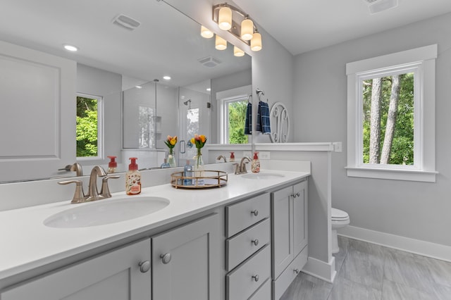 129 Martins Point Dr, Wando, SC 29492 - bathroom featuring double vanity, healthy amount of natural light, a shower stall, marble finish floors, and recessed lighting