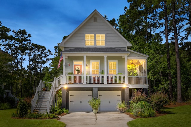 129 Martins Point Dr, Wando, SC 29492 - coastal home featuring stairs, driveway, a garage, a porch, and a front yard
