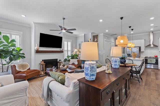 129 Martins Point Dr, Wando, SC 29492 - living area featuring healthy amount of natural light, a ceiling fan, recessed lighting, ornamental molding, and dark wood-style floors