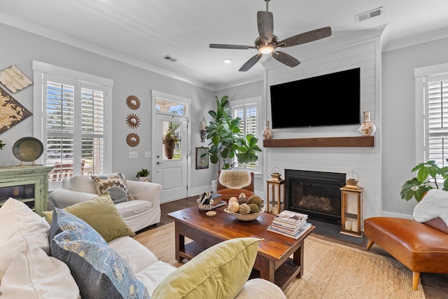129 Martins Point Dr, Wando, SC 29492 - living room featuring a fireplace, wood finished floors, plenty of natural light, a ceiling fan, and ornamental molding