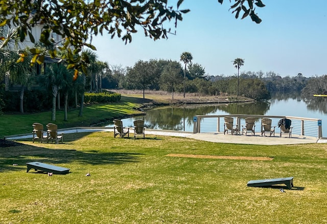 view of community with a yard and a water view