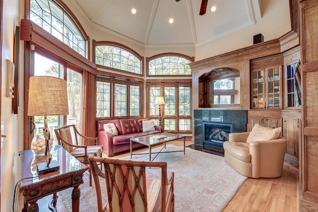 living room featuring recessed lighting, wood-type flooring, a high end fireplace, ceiling fan, and high vaulted ceiling