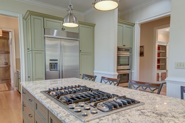 kitchen featuring light wood-style flooring, crown molding, appliances with stainless steel finishes, and green cabinetry