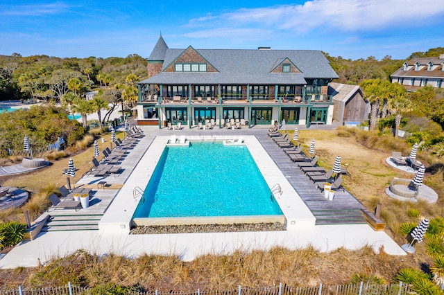 pool featuring a patio area and fence