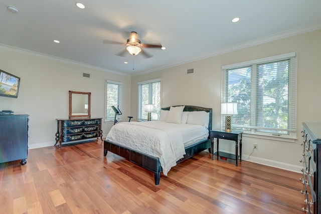 bedroom featuring baseboards, visible vents, and wood finished floors