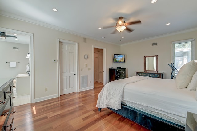 bedroom with light wood-style flooring, visible vents, and ornamental molding