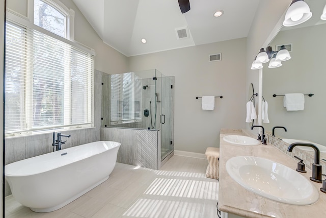 full bathroom featuring a freestanding tub, a stall shower, a sink, and visible vents