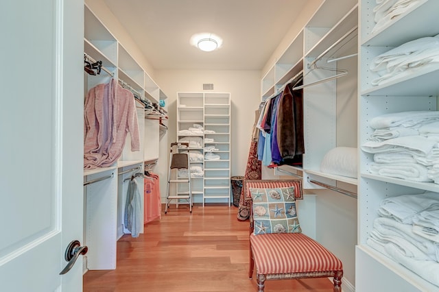 walk in closet with visible vents and wood finished floors