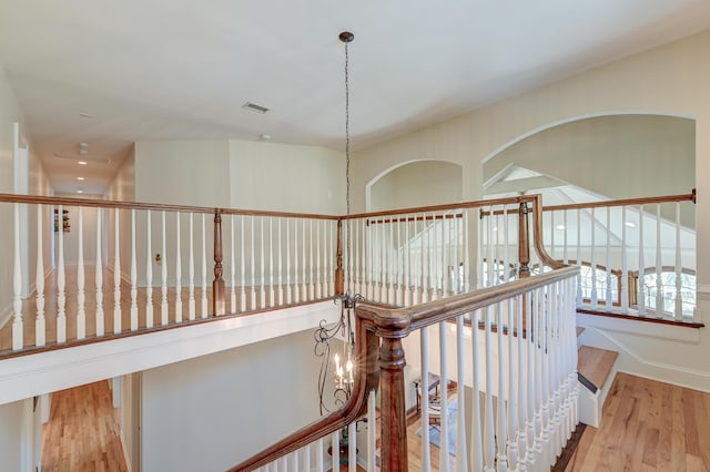 hallway with visible vents and wood finished floors