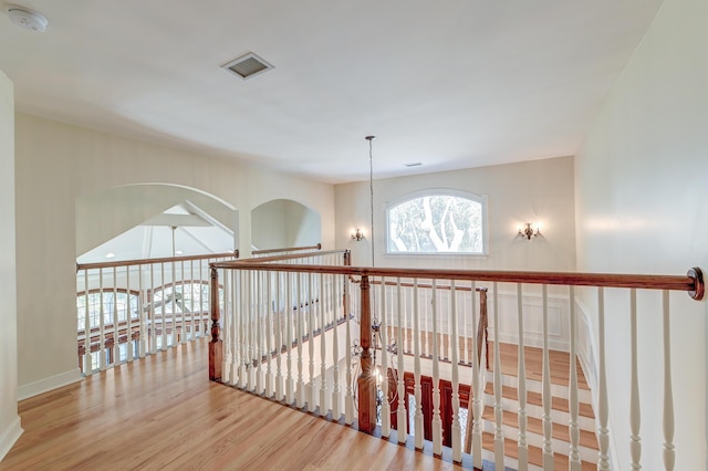 corridor featuring visible vents and wood finished floors