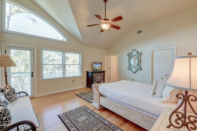 bedroom featuring visible vents, baseboards, light wood-style flooring, access to outside, and high vaulted ceiling