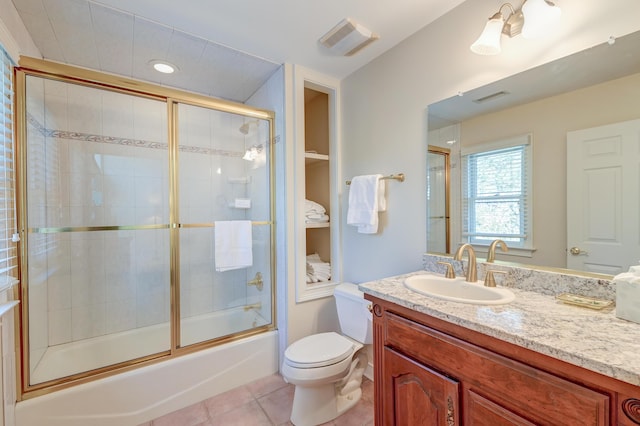 bathroom featuring enclosed tub / shower combo, tile patterned flooring, visible vents, and toilet