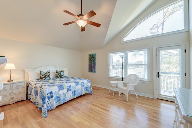 bedroom with light wood finished floors, access to outside, and vaulted ceiling