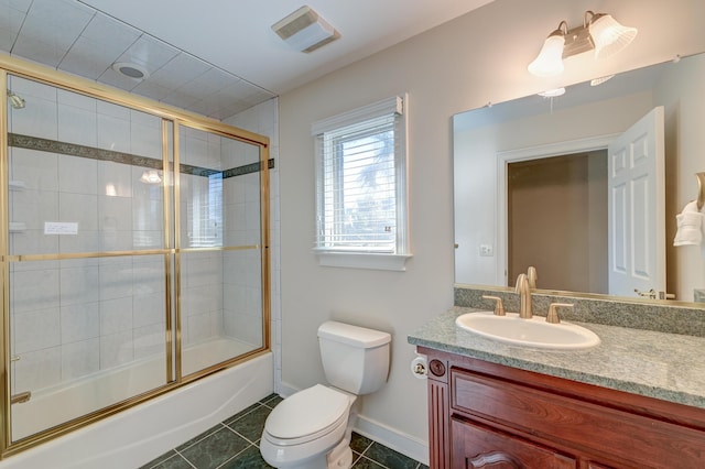 bathroom with visible vents, toilet, combined bath / shower with glass door, vanity, and tile patterned floors