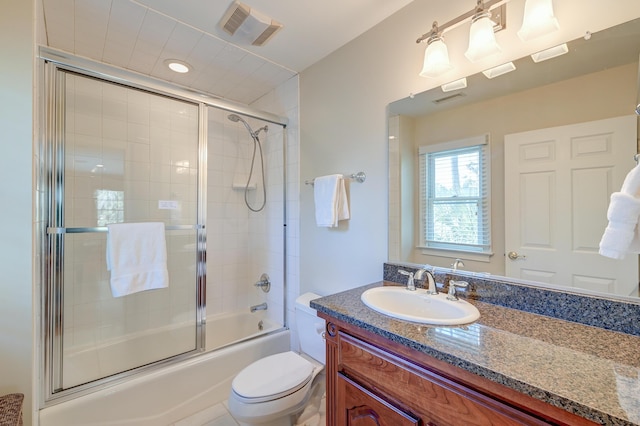 full bathroom with toilet, enclosed tub / shower combo, visible vents, and vanity