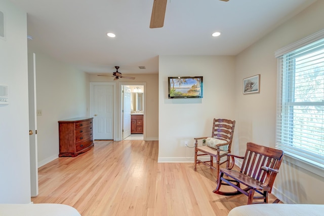 living area featuring light wood finished floors, ceiling fan, baseboards, and recessed lighting