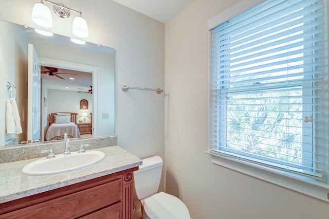 bathroom featuring toilet, ensuite bath, ceiling fan, and vanity