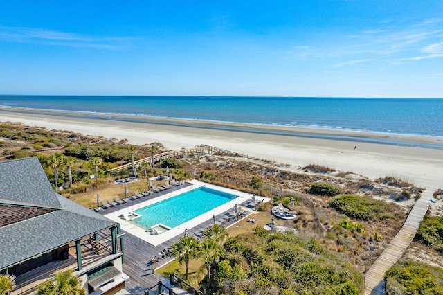 birds eye view of property featuring a view of the beach and a water view