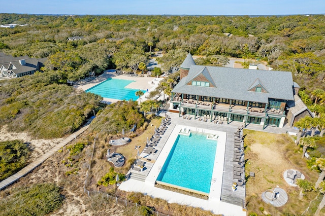 birds eye view of property with a view of trees