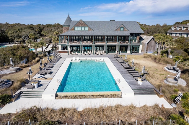 pool with a patio area and fence