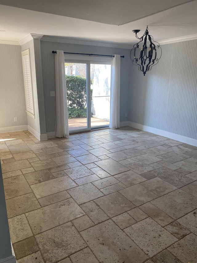 unfurnished room featuring ornamental molding, stone tile flooring, and baseboards