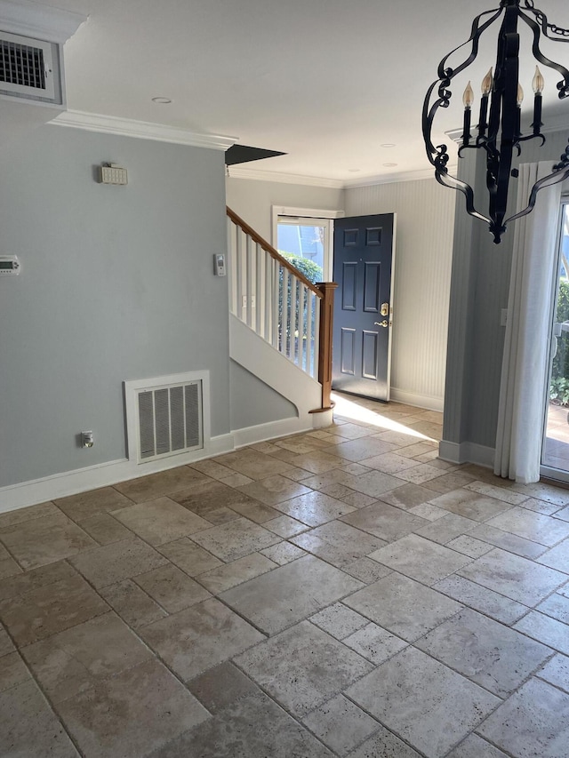 foyer featuring baseboards, visible vents, and crown molding