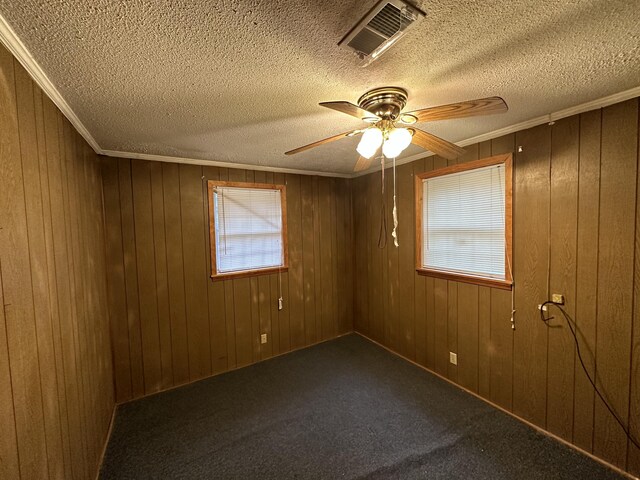 135 Golden Ave, Eutawville, SC 29048 - carpeted spare room featuring ceiling fan, ornamental molding, and wooden walls