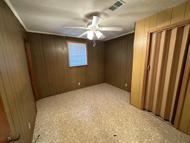 135 Golden Ave, Eutawville, SC 29048 - empty room with wood walls, ornamental molding, and a textured ceiling