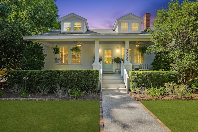 2060 Wappoo Hall Rd, Charleston, SC 29412 - view of front of house with covered porch, a chimney, a lawn, and a shingled roof