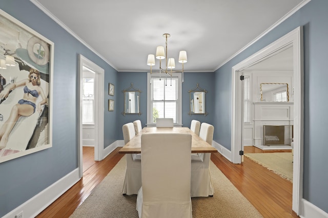 2060 Wappoo Hall Rd, Charleston, SC 29412 - dining space with wood finished floors, ornamental molding, a chandelier, and baseboards
