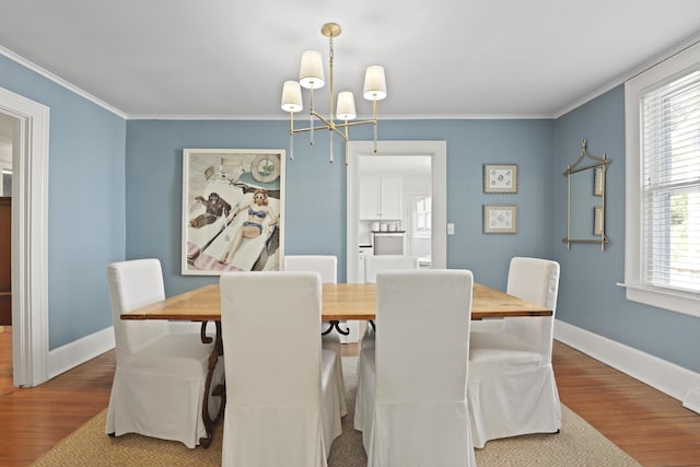 2060 Wappoo Hall Rd, Charleston, SC 29412 - dining space with wood finished floors, a chandelier, crown molding, and baseboards