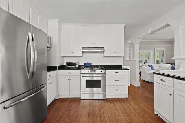 2060 Wappoo Hall Rd, Charleston, SC 29412 - kitchen featuring appliances with stainless steel finishes, under cabinet range hood, decorative columns, dark wood-style floors, and open floor plan