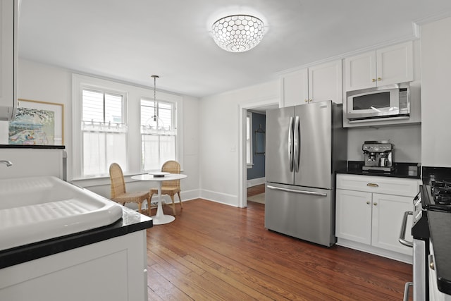2060 Wappoo Hall Rd, Charleston, SC 29412 - kitchen with stainless steel appliances, white cabinetry, a sink, and dark wood-style flooring