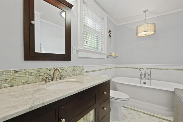 2060 Wappoo Hall Rd, Charleston, SC 29412 - full bathroom with a freestanding tub, tile patterned floors, vanity, toilet, and wainscoting