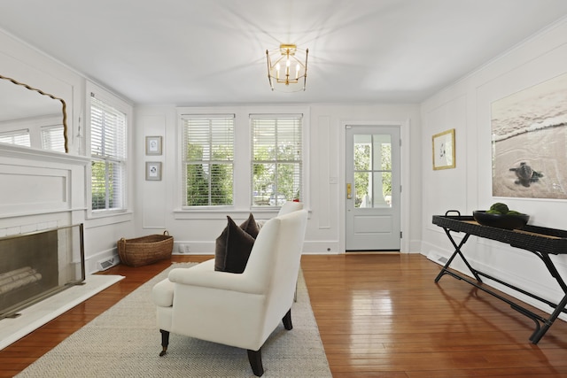 2060 Wappoo Hall Rd, Charleston, SC 29412 - living area featuring hardwood / wood-style flooring, a chandelier, and a fireplace with raised hearth