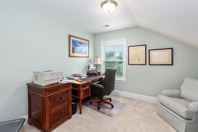 office with lofted ceiling and light carpet