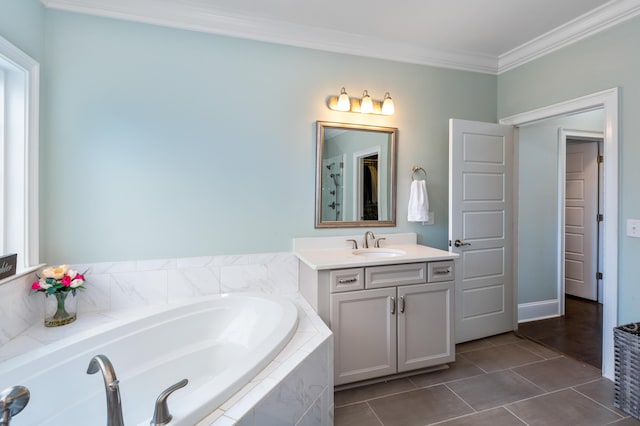 bathroom with crown molding, tile patterned flooring, vanity, and a relaxing tiled tub