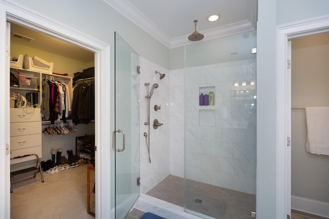 bathroom featuring a shower with door and crown molding