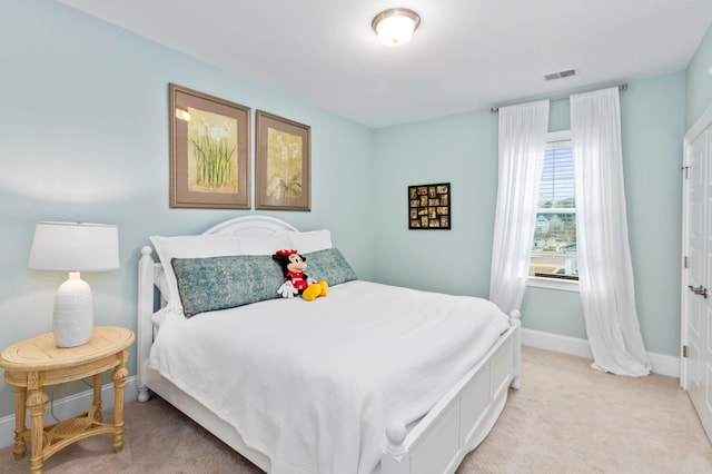 bedroom with light colored carpet