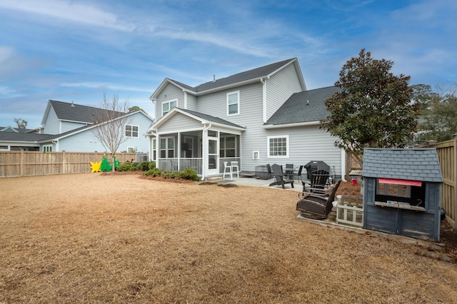 back of house featuring a sunroom and a patio area