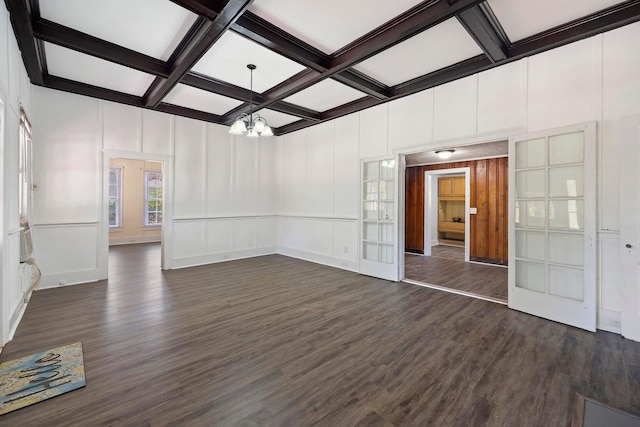 spare room featuring beam ceiling, coffered ceiling, french doors, and dark hardwood / wood-style floors